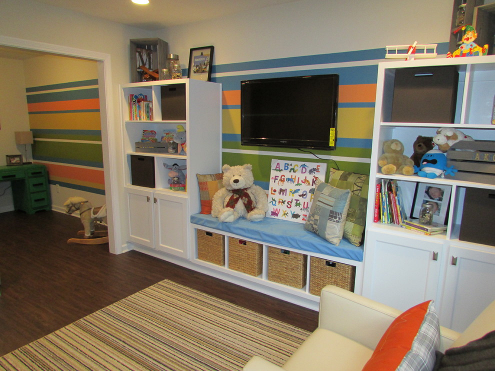 This is an example of a medium sized gender neutral kids' bedroom in Indianapolis with beige walls, vinyl flooring and brown floors.
