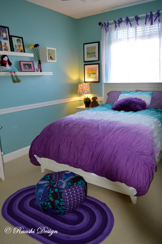 This is an example of a medium sized contemporary kids' bedroom for girls in San Francisco with blue walls and carpet.