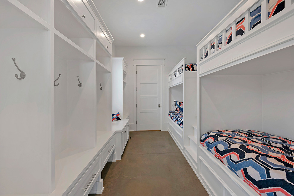 Photo of a medium sized nautical gender neutral children’s room in Miami with white walls and concrete flooring.