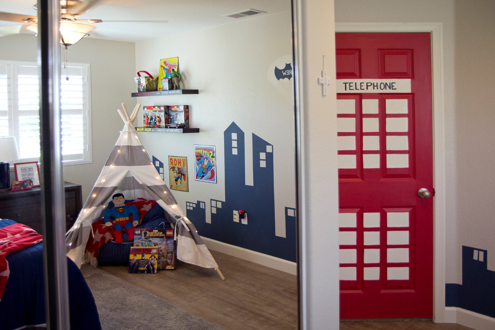 Medium sized bohemian children’s room for boys in San Diego with beige walls and medium hardwood flooring.