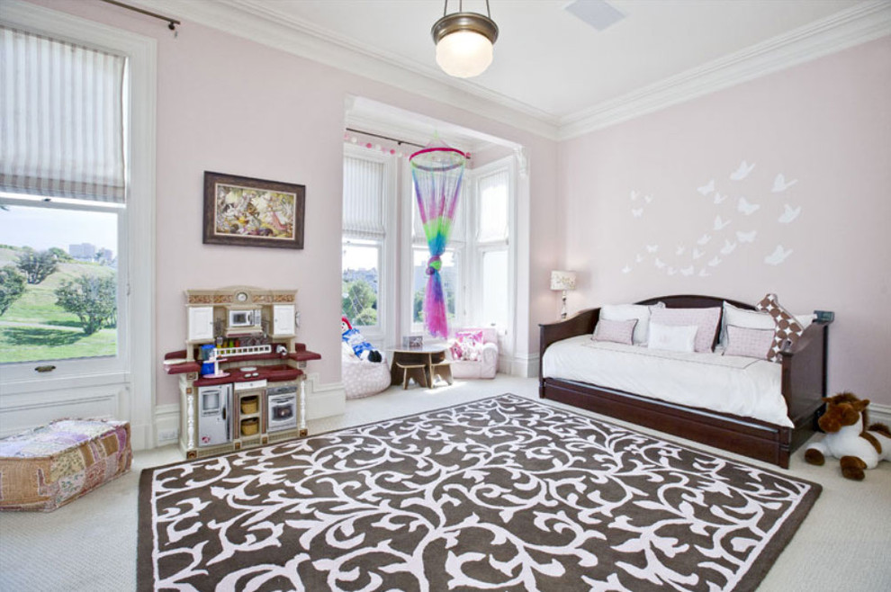 Large eclectic girl carpeted kids' room photo in San Francisco with pink walls