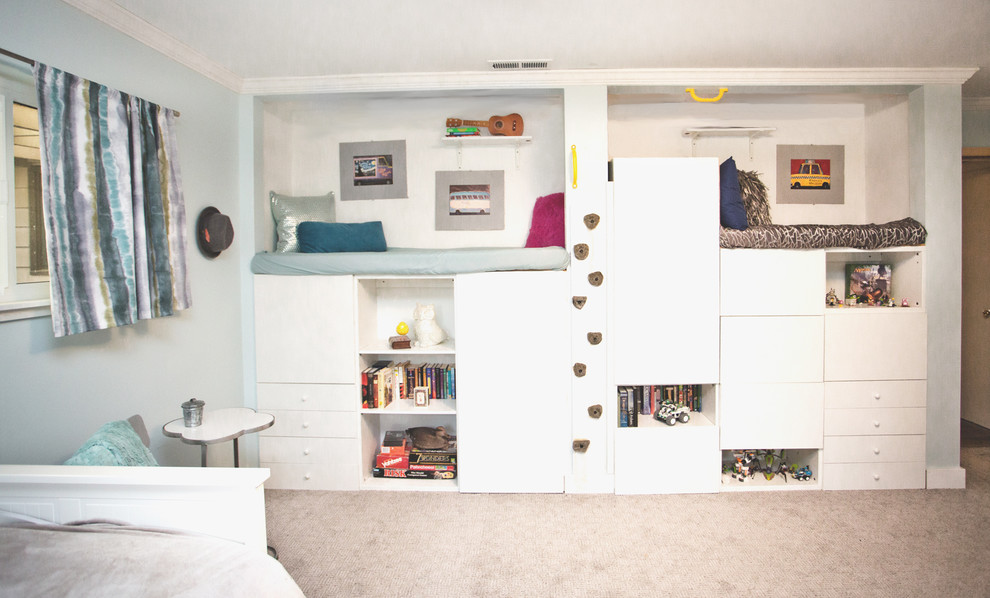 Medium sized traditional gender neutral children’s room in Portland with blue walls, carpet and beige floors.