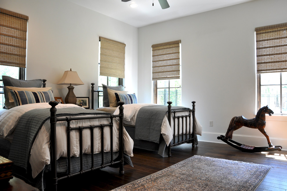 Traditional gender neutral children’s room in Houston with grey walls and dark hardwood flooring.