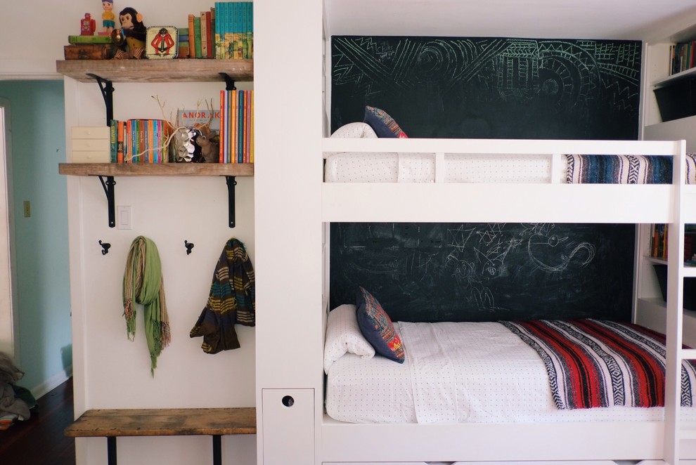 Example of a mid-sized eclectic gender-neutral dark wood floor and brown floor kids' room design in Austin with white walls