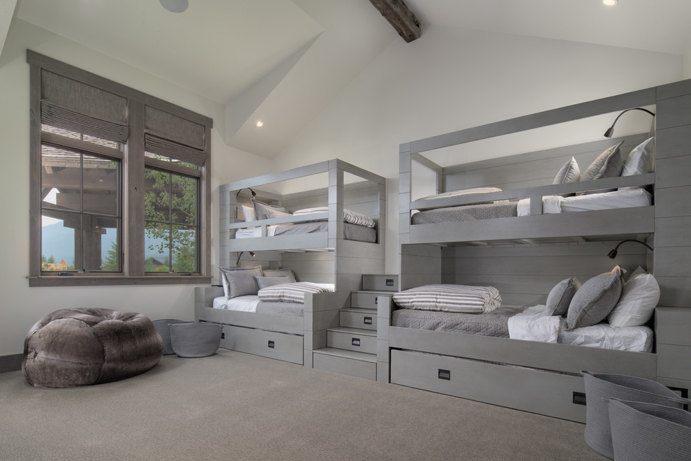 Photo of a rustic gender neutral kids' bedroom in Other with white walls, carpet and grey floors.