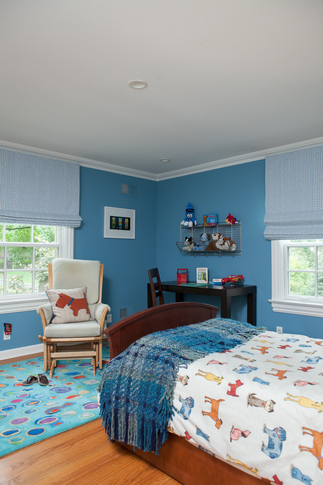 Inspiration for a medium sized traditional children’s room for boys in New York with blue walls, light hardwood flooring and beige floors.