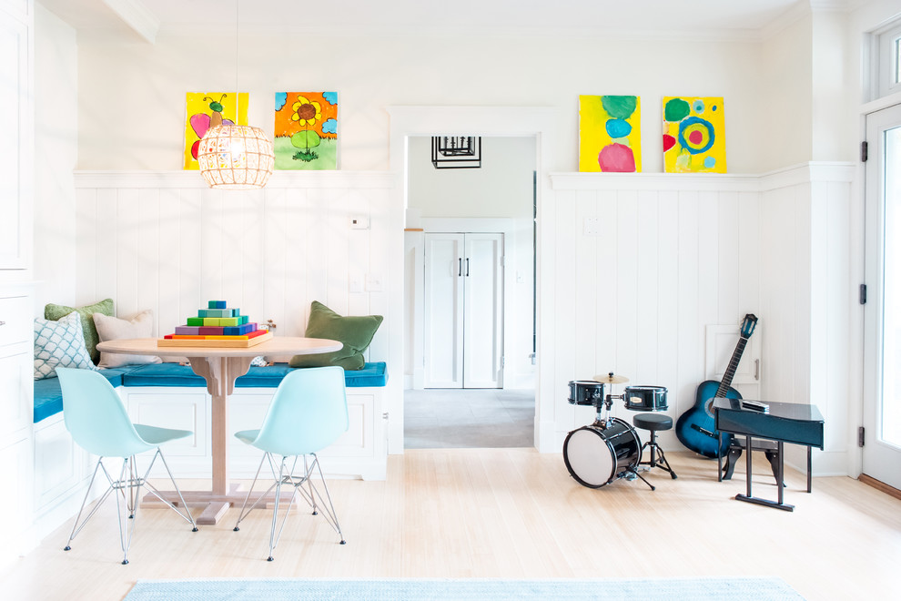 Example of a mid-sized transitional light wood floor kids' room design in Burlington with white walls