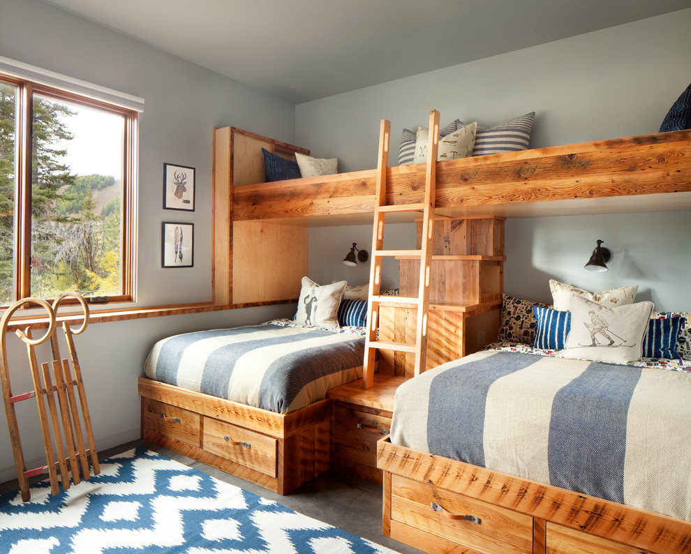 This is an example of a rustic kids' bedroom in Other with grey walls and grey floors.