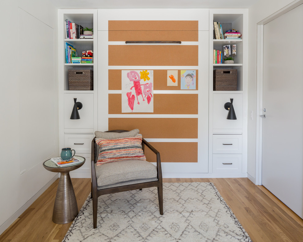Example of a transitional gender-neutral light wood floor kids' room design in Philadelphia with white walls