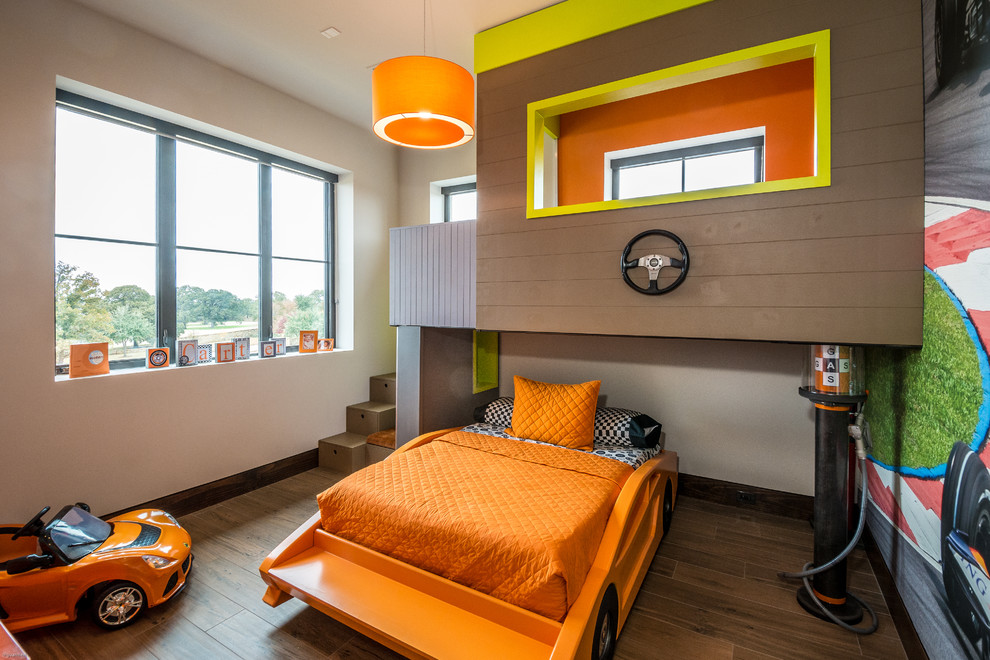 This is an example of a large contemporary children’s room for boys in Orange County with multi-coloured walls, porcelain flooring and brown floors.