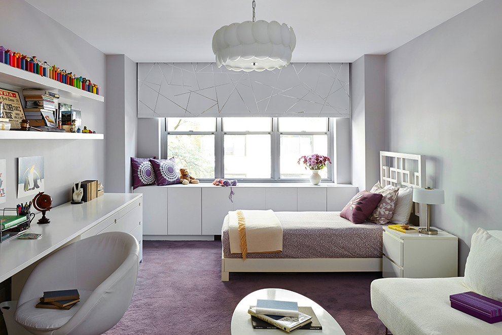 This is an example of a medium sized contemporary teen’s room for girls in New York with carpet, purple floors and grey walls.