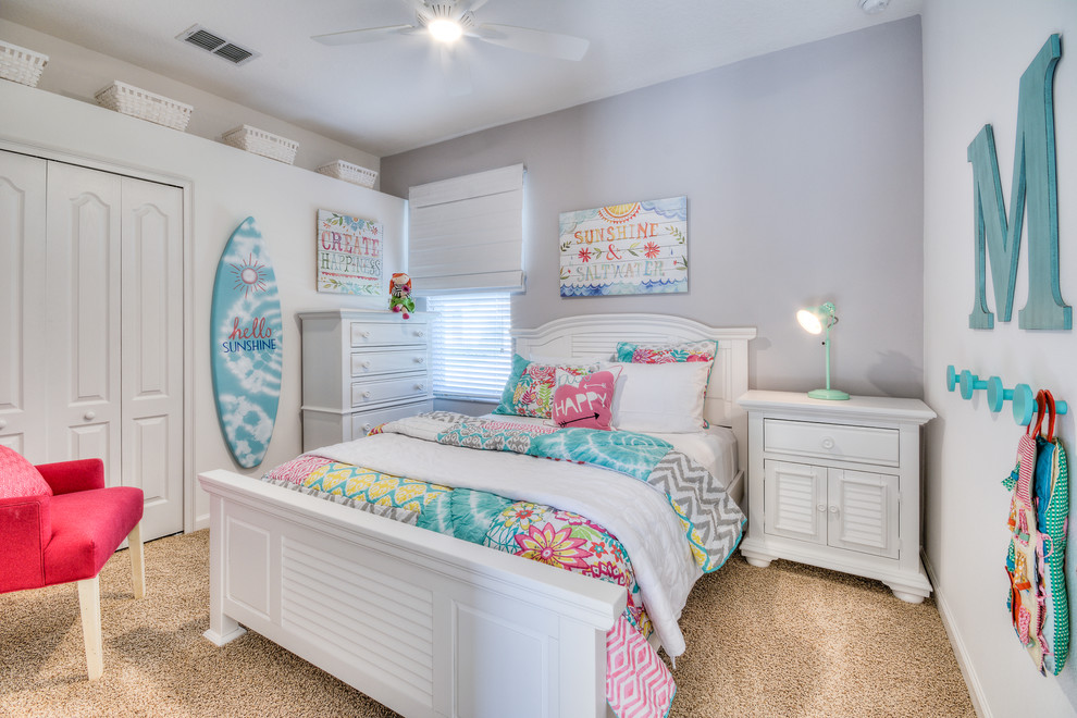 Mid-sized beach style girl carpeted and beige floor kids' room photo in Orlando with white walls