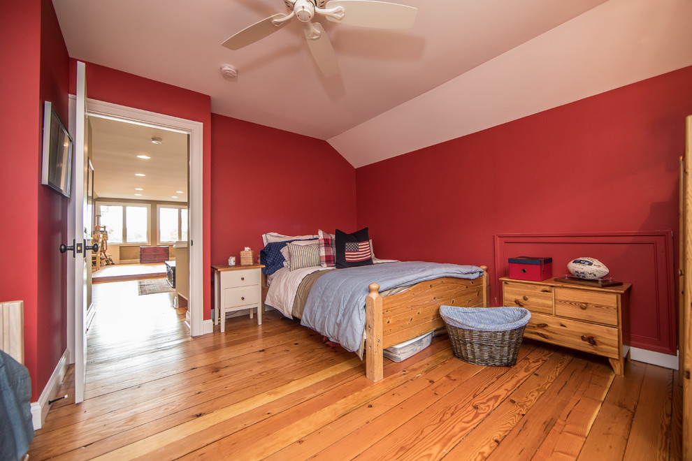 Design ideas for a medium sized rustic gender neutral children’s room in DC Metro with red walls, medium hardwood flooring and brown floors.