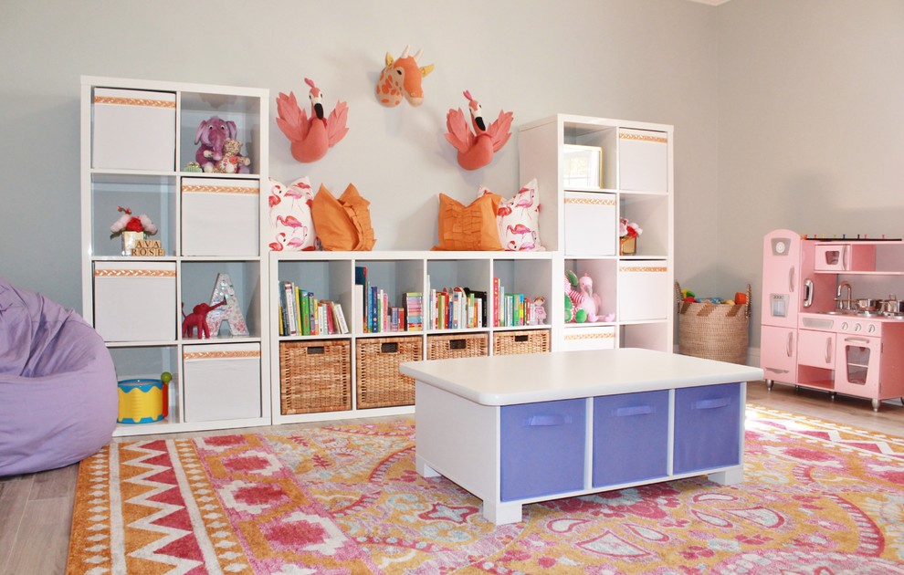 Eclectic kids' bedroom for girls in Tampa with grey walls and brown floors.