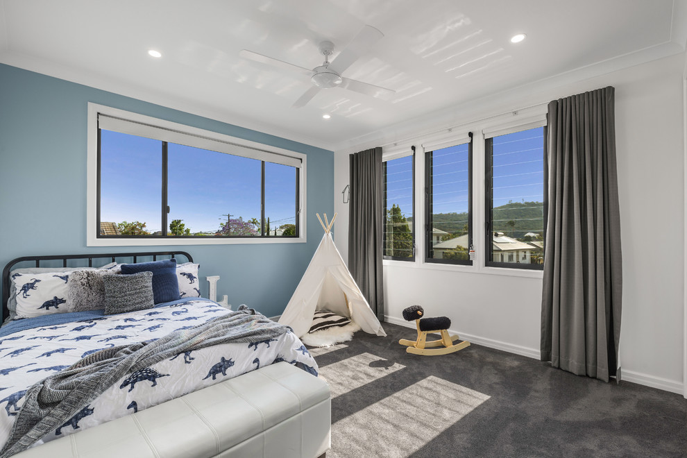 Medium sized contemporary children’s room for boys in Brisbane with blue walls, carpet and grey floors.