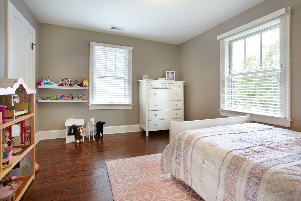 This is an example of a medium sized traditional children’s room for girls in Minneapolis with grey walls and medium hardwood flooring.