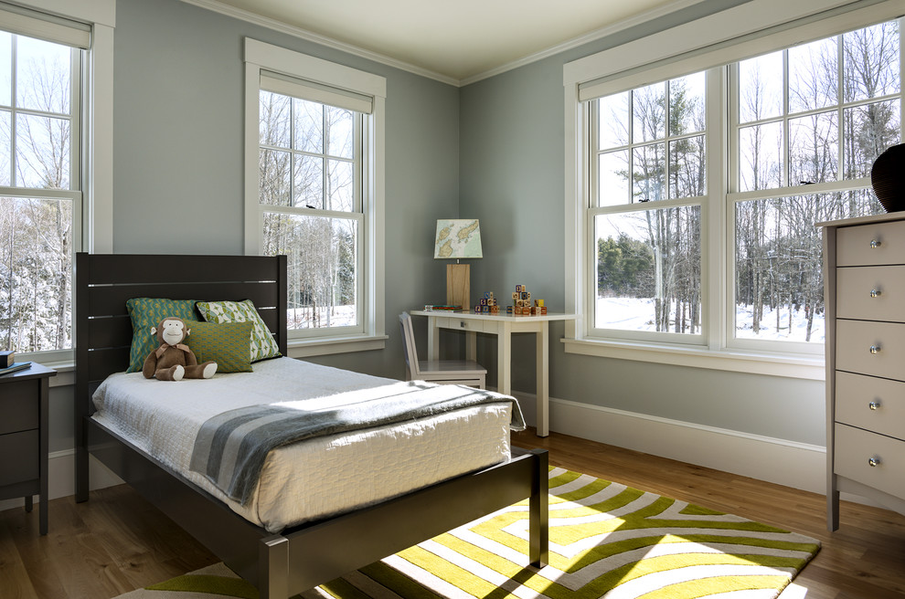 Mid-sized elegant gender-neutral medium tone wood floor kids' room photo in Portland Maine with blue walls