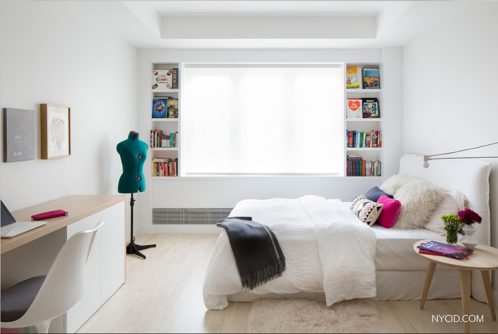 This is an example of a medium sized contemporary kids' bedroom for girls in New York with white walls and light hardwood flooring.
