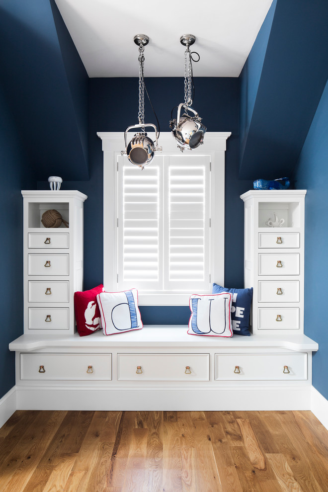 Large nautical gender neutral kids' bedroom in Boston with blue walls and medium hardwood flooring.