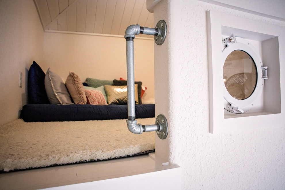 Photo of a small farmhouse gender neutral kids' bedroom in Dallas with beige walls, carpet and beige floors.