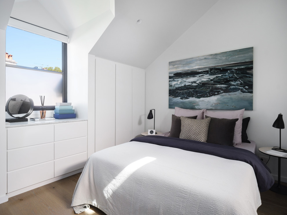 Example of a mid-sized trendy beige floor bedroom design in Sydney with white walls