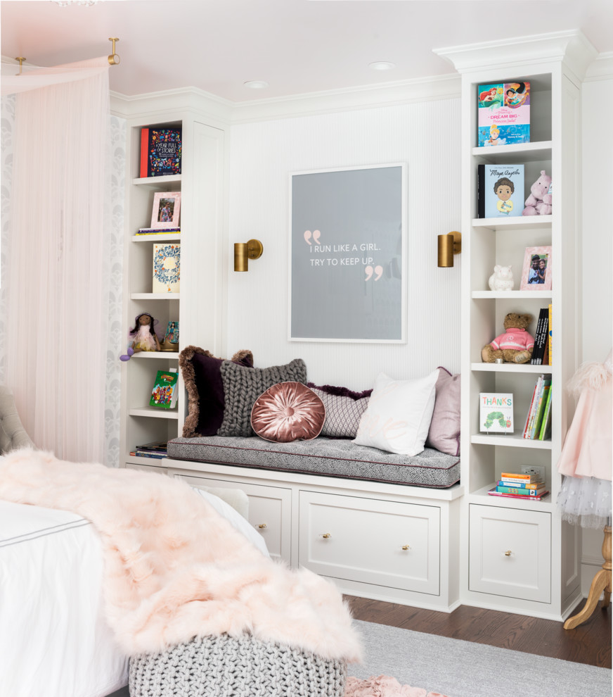 This is an example of a medium sized classic children’s room for girls in New York with white walls, medium hardwood flooring and brown floors.