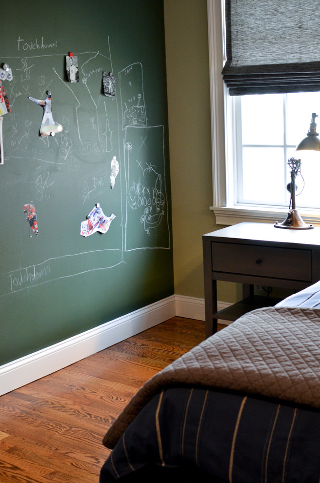 This is an example of a medium sized contemporary children’s room for boys in New York with beige walls and dark hardwood flooring.
