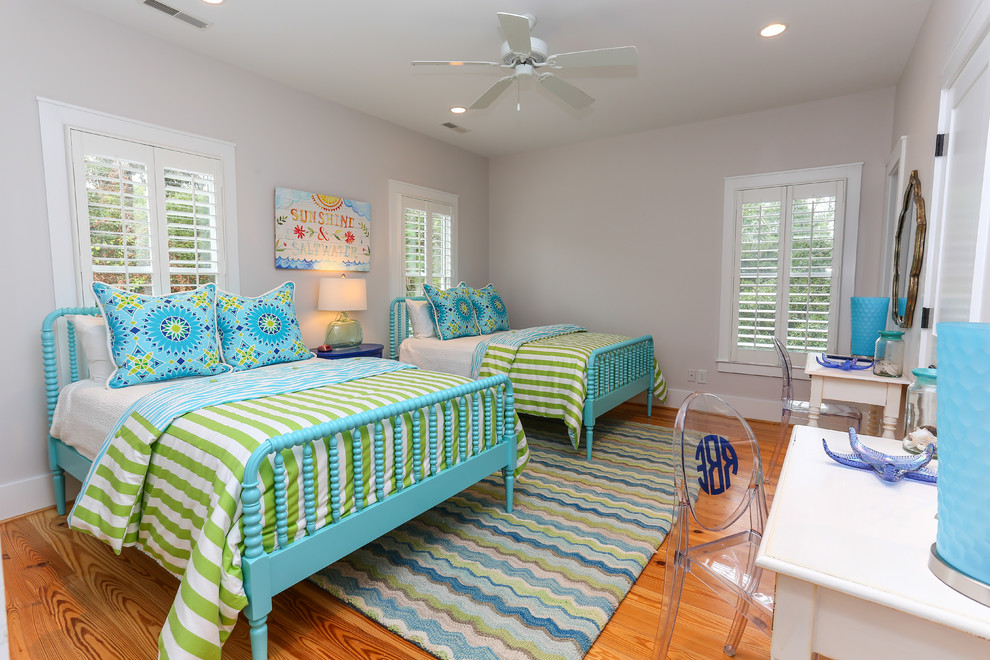 Imagen de dormitorio infantil costero de tamaño medio con paredes blancas y suelo de madera en tonos medios