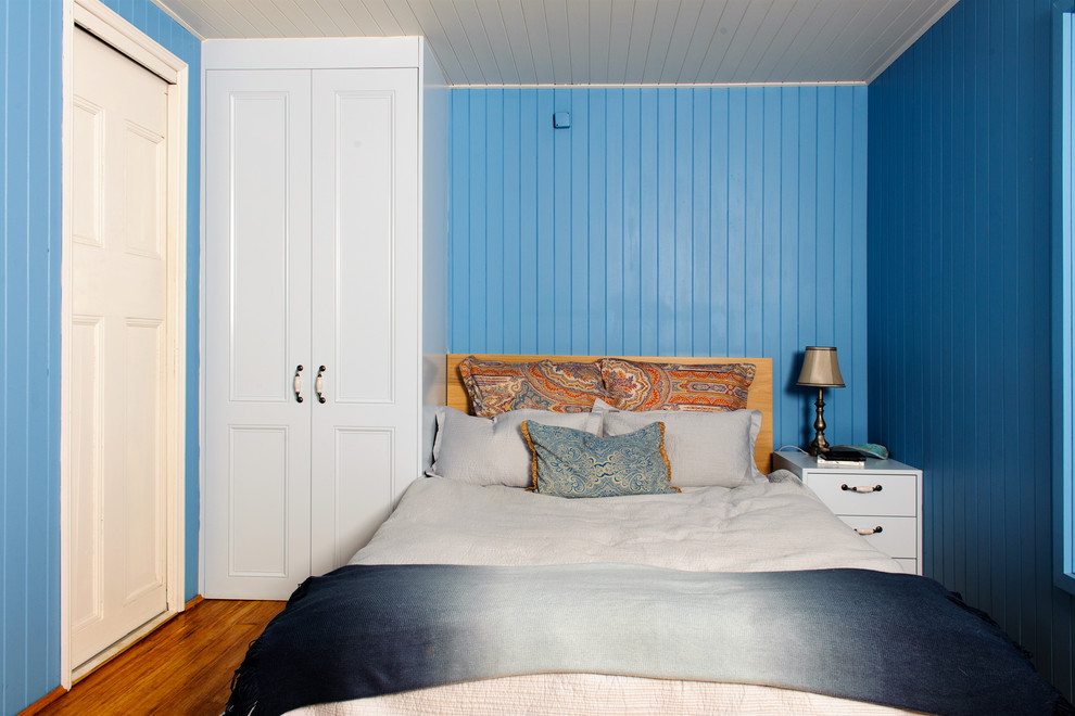 Example of a mid-sized transitional boy dark wood floor and brown floor kids' room design in Sydney with blue walls