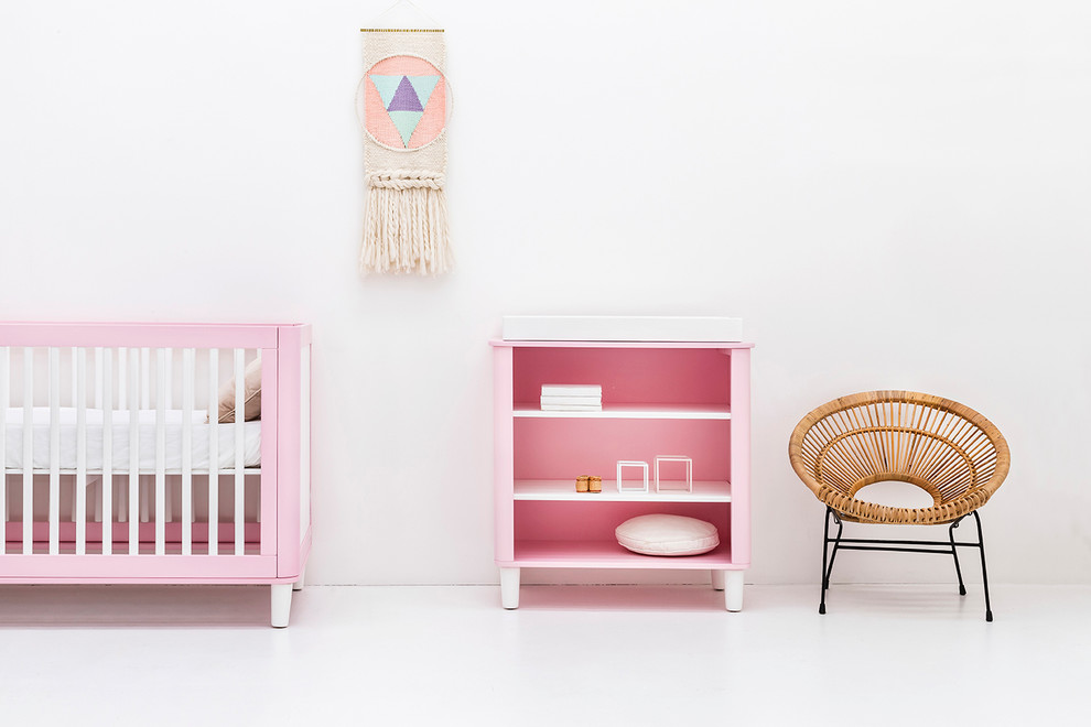 This is an example of a small contemporary toddler’s room for girls in Sydney with white walls.
