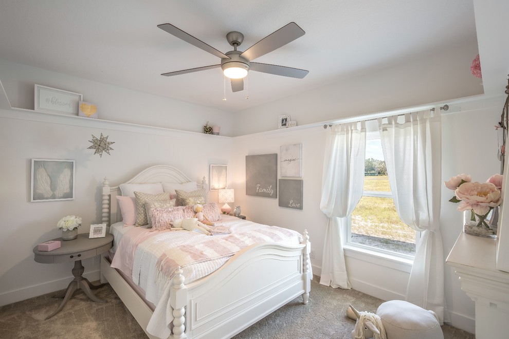 Photo of a classic kids' bedroom for girls in Jacksonville with white walls, carpet and beige floors.