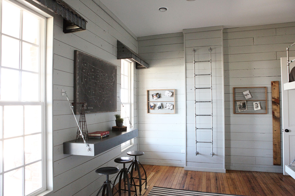 Kids' room - mid-sized farmhouse boy medium tone wood floor kids' room idea in Austin with white walls
