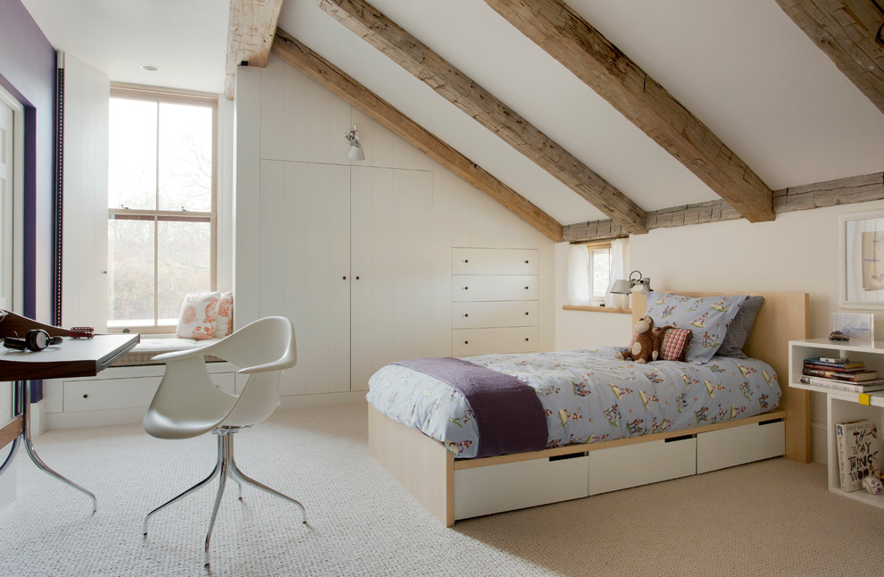 This is an example of a farmhouse gender neutral kids' bedroom in Boston with white walls and carpet.