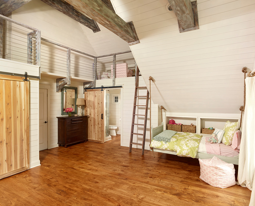 Photo of a large nautical kids' bedroom for girls in Charleston with beige walls, medium hardwood flooring and brown floors.