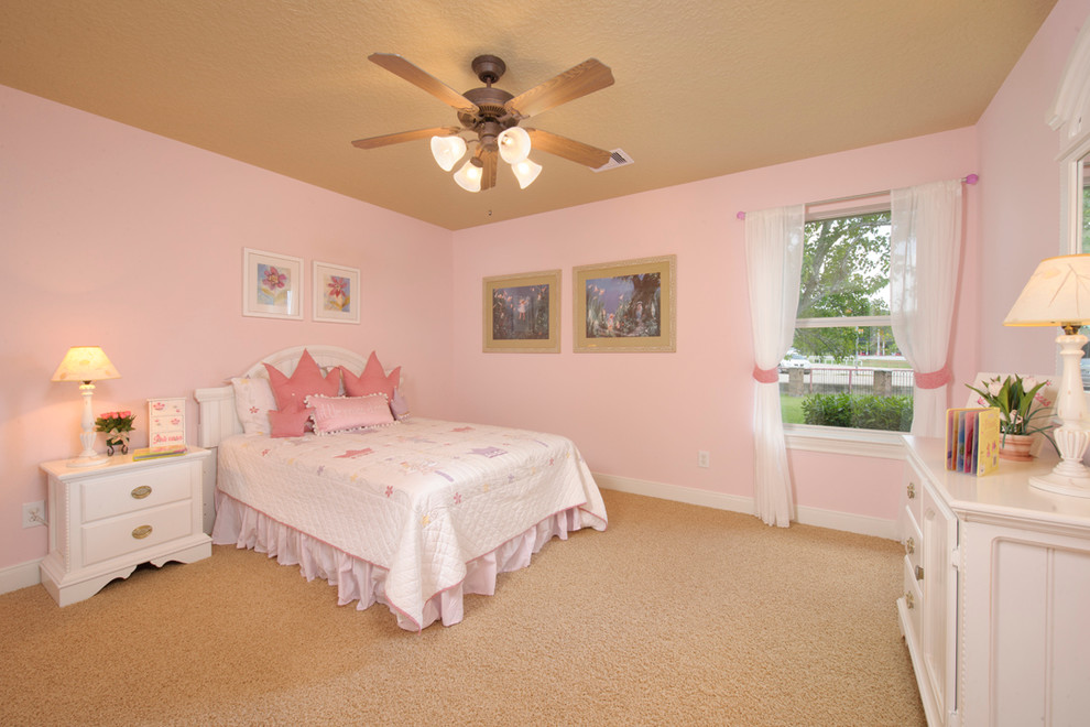 Medium sized classic children’s room for girls in Houston with pink walls, carpet and beige floors.