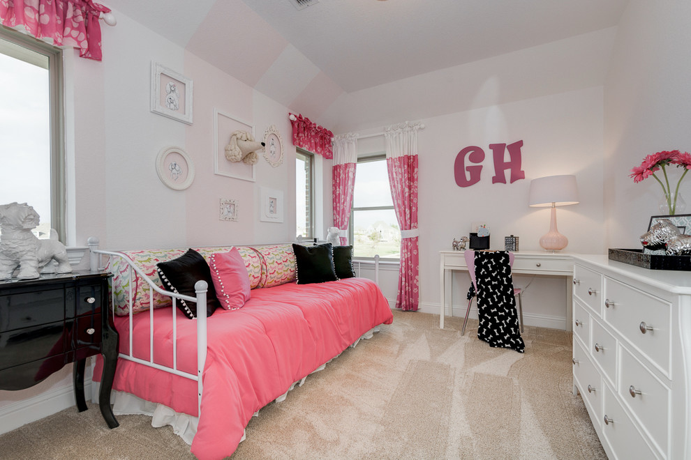 This is an example of a classic teen’s room for girls in Dallas with pink walls and carpet.