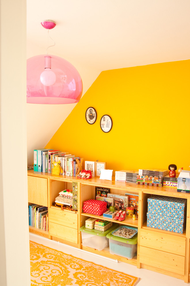 This is an example of a bohemian gender neutral kids' bedroom in Amsterdam with multi-coloured walls.