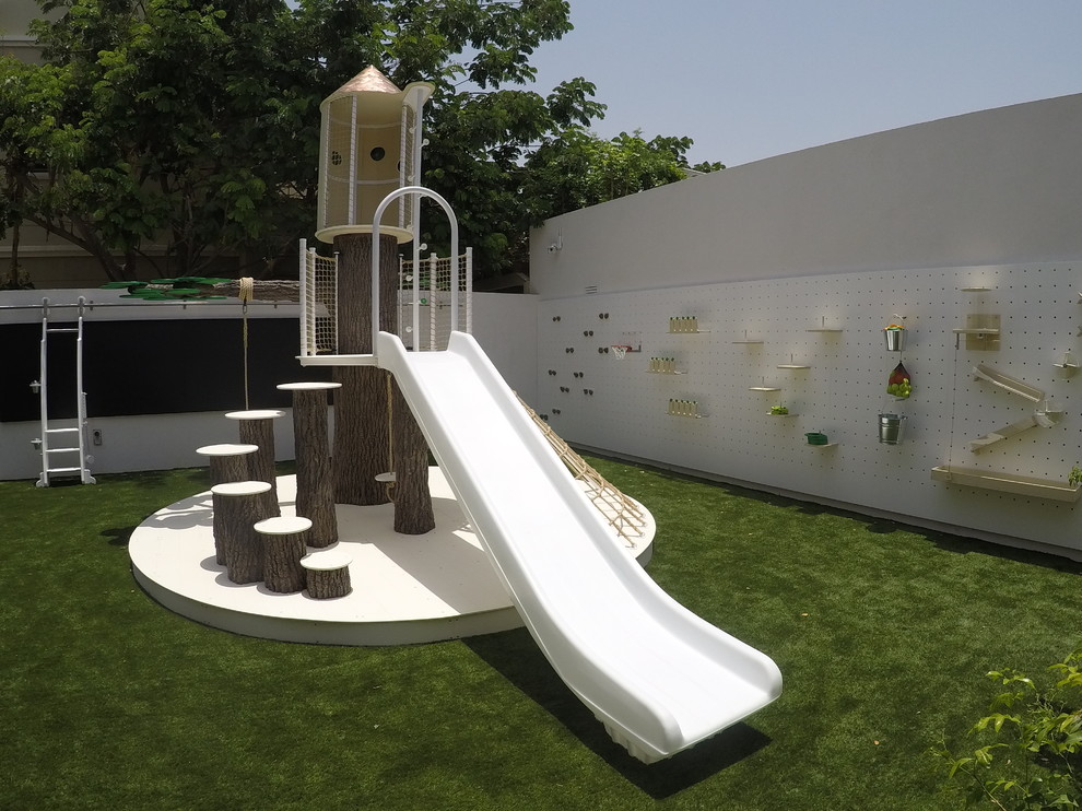 Bild på ett mycket stort funkis könsneutralt barnrum kombinerat med lekrum och för 4-10-åringar, med vita väggar och grönt golv