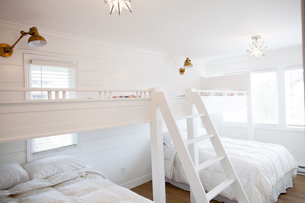 Example of a large beach style gender-neutral medium tone wood floor kids' room design in San Francisco with white walls