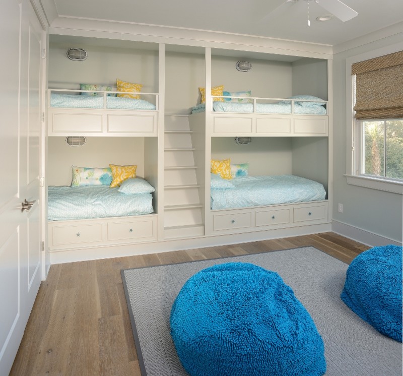 Imagen de dormitorio infantil de 4 a 10 años costero de tamaño medio con paredes beige y suelo de madera en tonos medios