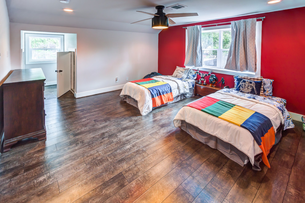 Photo of a large classic children’s room for boys in Houston with multi-coloured walls, laminate floors and brown floors.