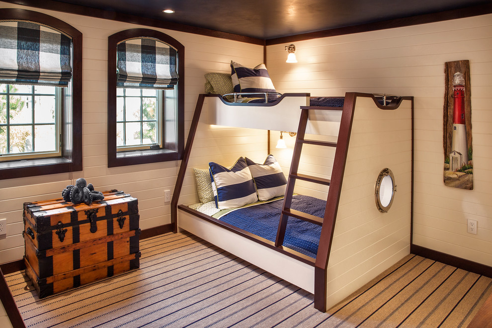 Design ideas for a large nautical children’s room for boys in New York with beige walls, carpet and feature lighting.