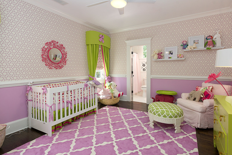 This is an example of a medium sized traditional toddler’s room for girls in Atlanta with purple walls, carpet and purple floors.