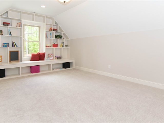 Example of a large cottage chic gender-neutral carpeted kids' room design in Raleigh with gray walls