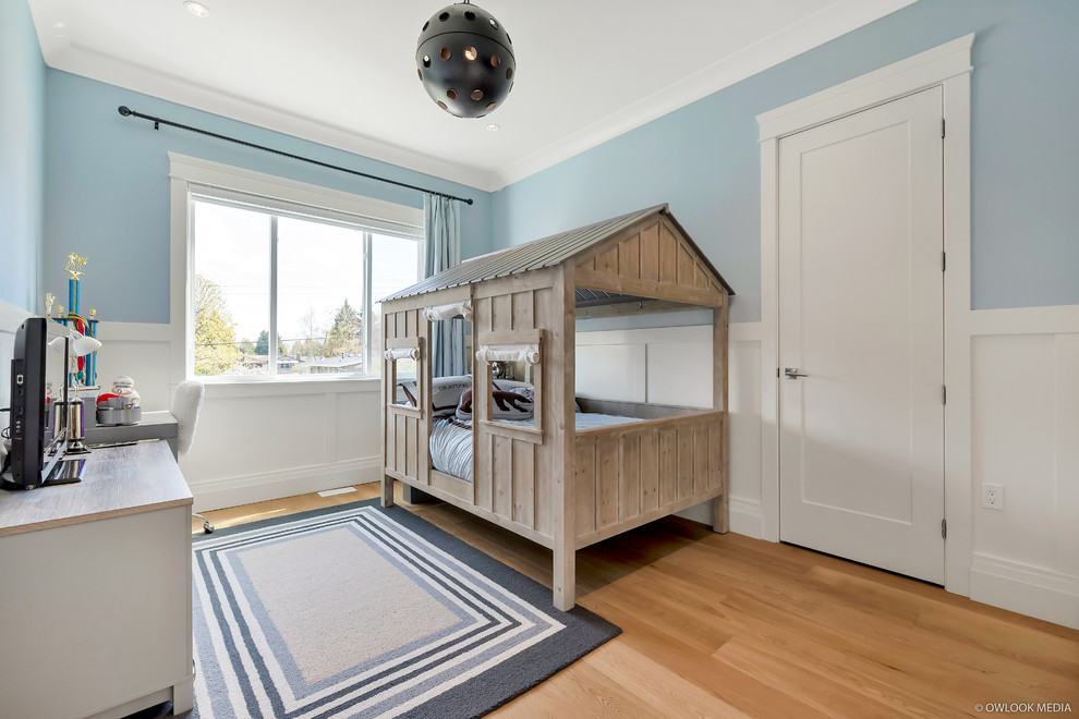 Kids' room - small transitional boy light wood floor and beige floor kids' room idea in Vancouver with blue walls