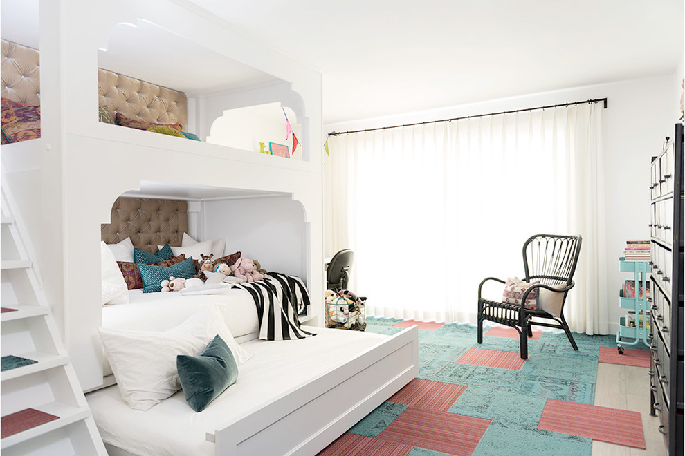 Example of a mid-sized trendy girl medium tone wood floor kids' room design in Los Angeles with white walls