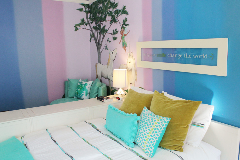 Photo of an eclectic children’s room for girls in San Francisco with multi-coloured walls and medium hardwood flooring.