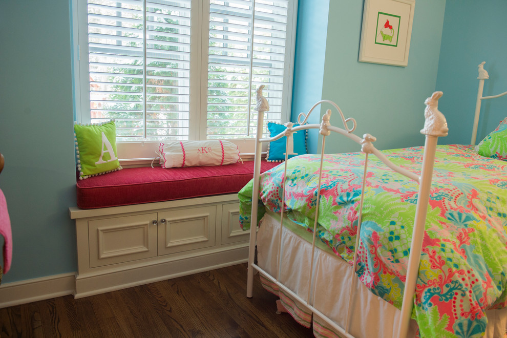 This is an example of a large beach style children’s room for girls in Minneapolis with blue walls, dark hardwood flooring and brown floors.