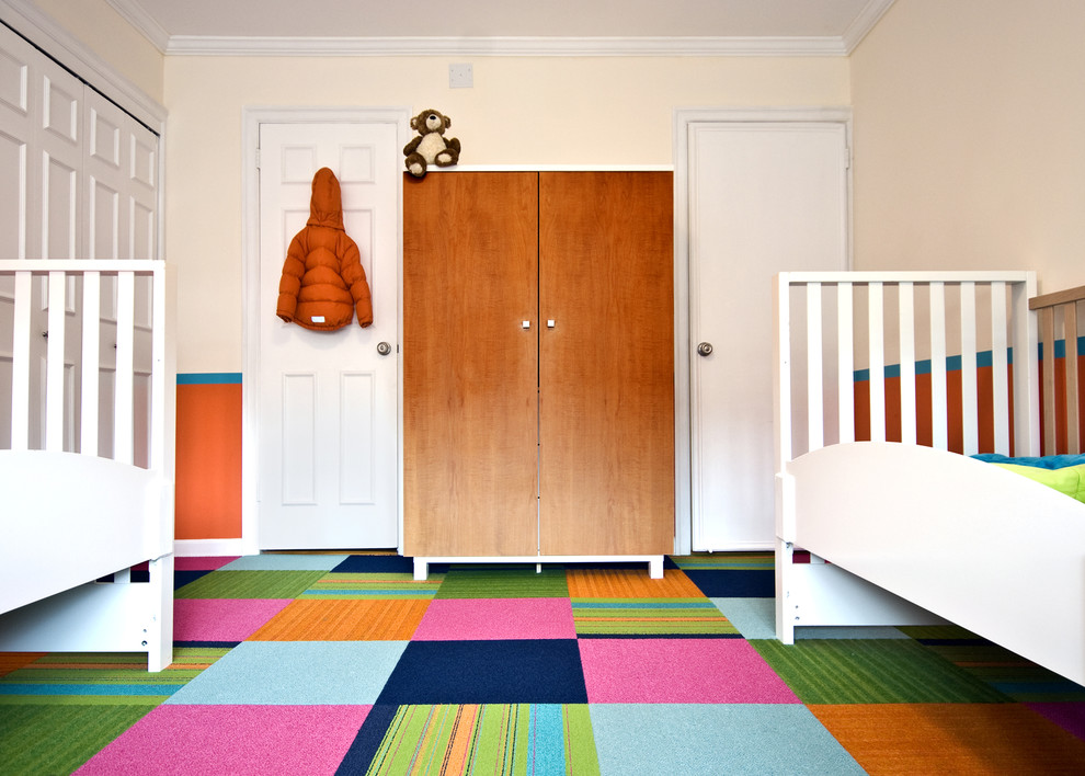 Trendy gender-neutral carpeted and multicolored floor kids' room photo in New York with orange walls