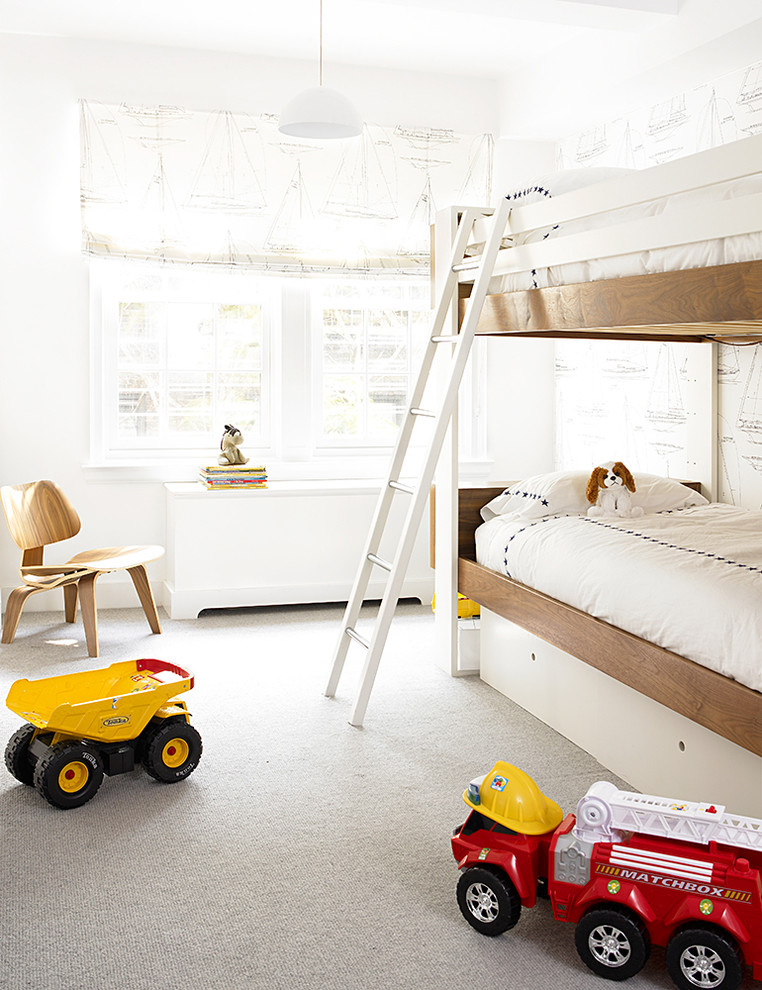 Photo of a classic gender neutral kids' bedroom in New York with white walls, carpet and grey floors.
